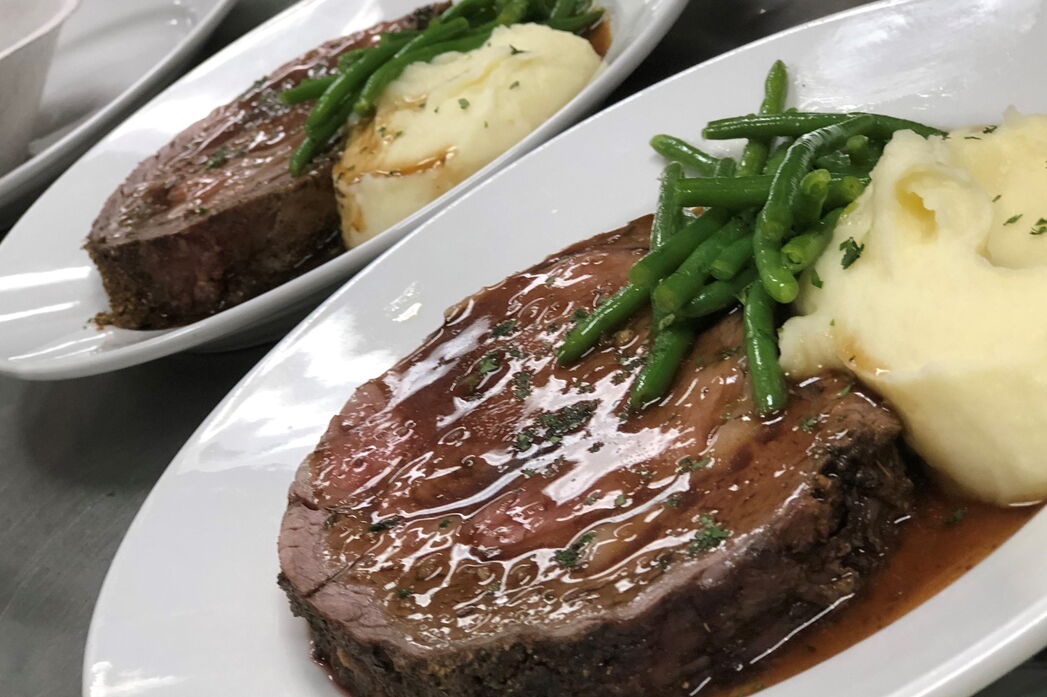 Steak on plate with potatoes and green beans