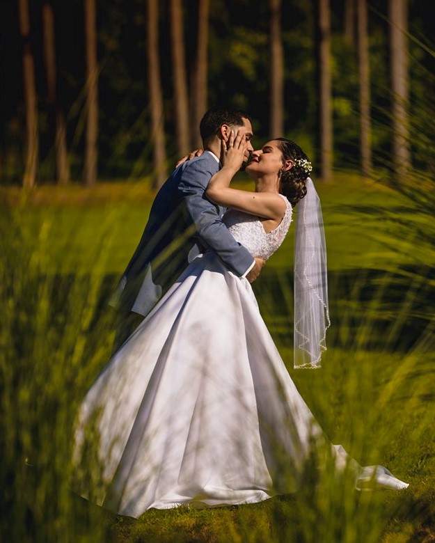 Groom dipping bride